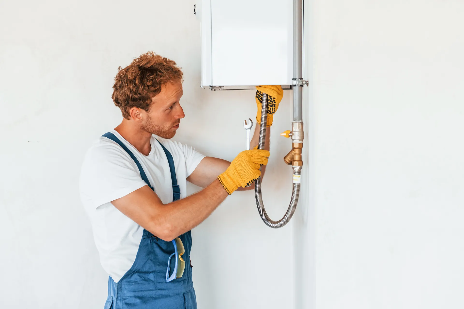 Plumber repairing a residential water heater